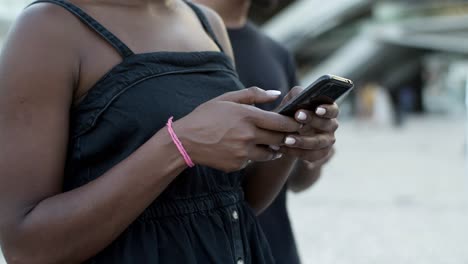 beautiful joyful woman typing on modern phone