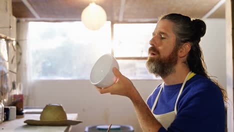 Male-potter-polishing-a-bowl