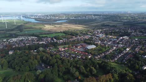 cheshire farmland countryside wind farm turbines generating renewable green energy aerial view push in tilt down