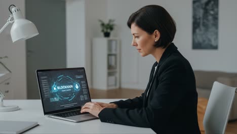 a professional woman engaged with blockchain technology on her laptop in a modern office setting, exploring innovations in digital security and finance