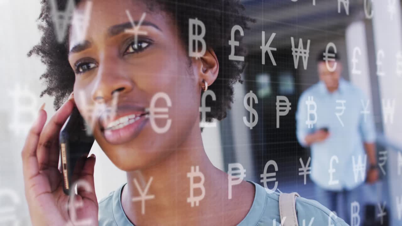 Animation of currency symbols over african american woman talking on smartphone outdoors