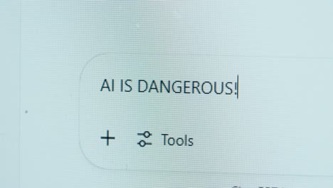 a bold statement appears on screen as a user types “ai is dangerous!” into a chat window, highlighting concerns about artificial intelligence and ethical risks