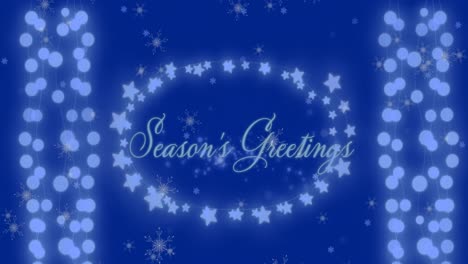 Animation-of-snowflakes-falling-over-seasons-greetings-text-and-fairy-lights-on-blue-background