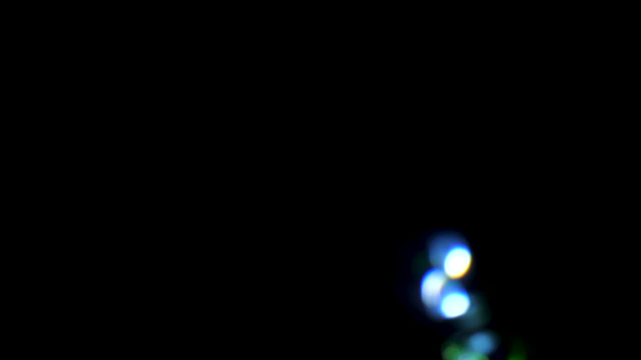 Visual abstract blurred blinking lights on black background
