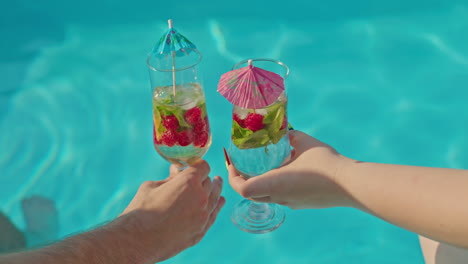 toasting drinks by the pool