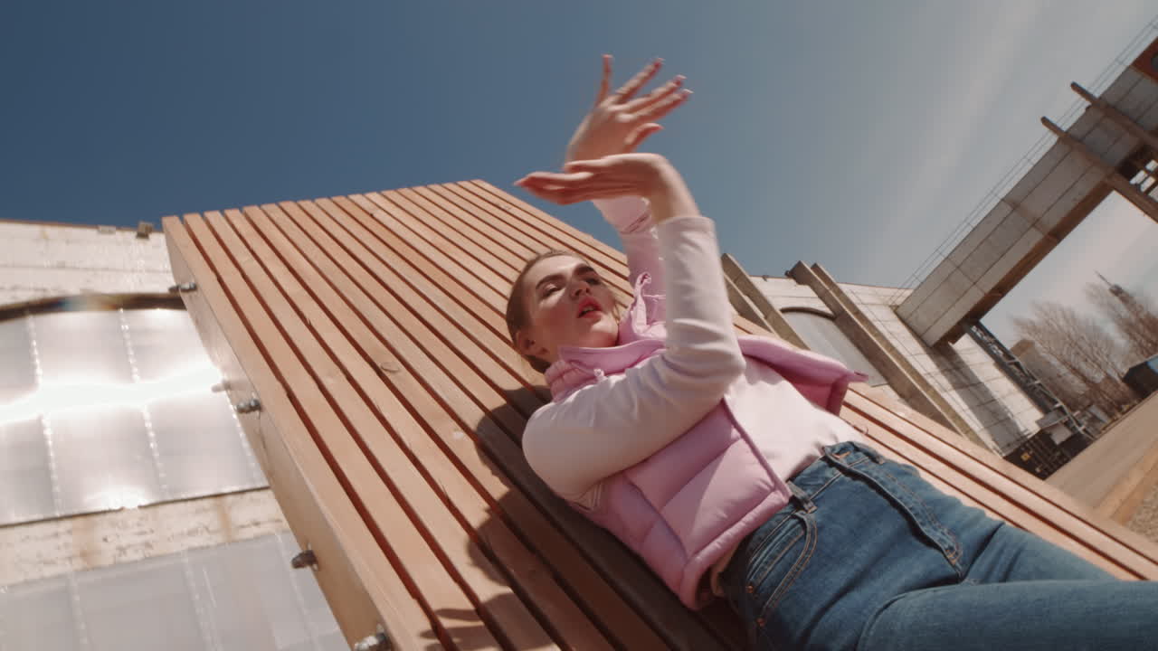 Woman Dancing by Wooden Wall Outdoors