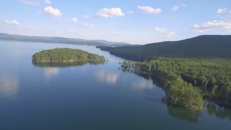 aerial view of a lake with islands and forests