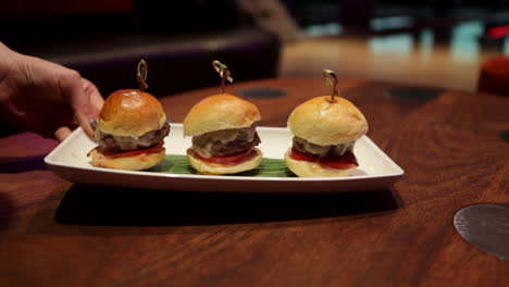 a tray of delicious beef sliders is served at a restaurant