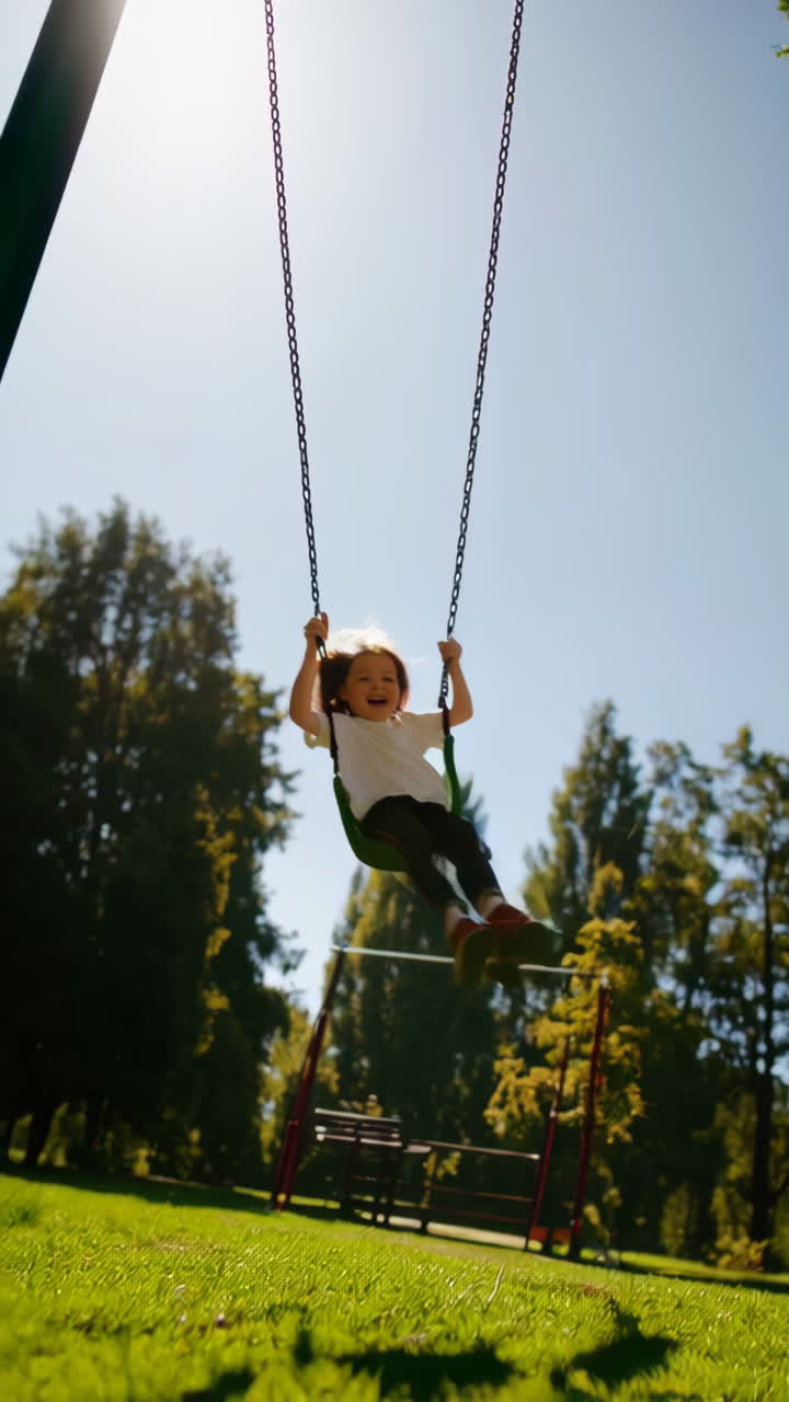 Joyful child swinging high on a playground