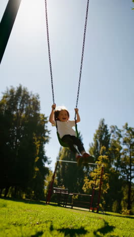 joyful child swinging high on a playground