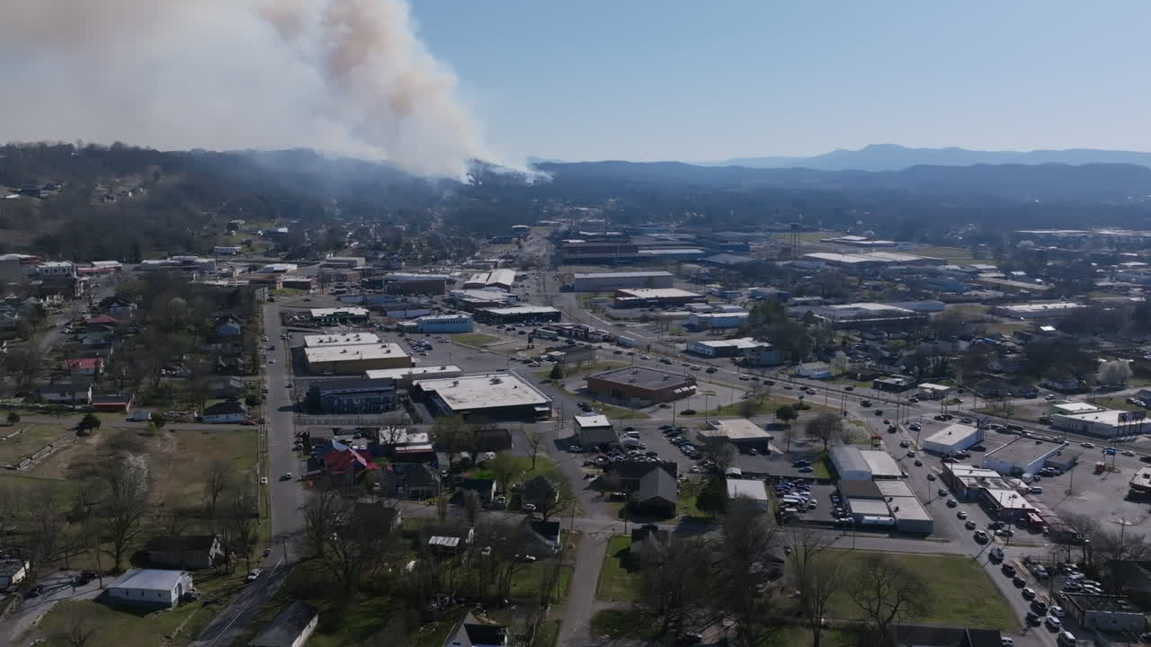 Aerial drone footage of the intersection of Dodds Ave and Rossville Blvd with a large forest fire in Rossville, Georgia in the background.