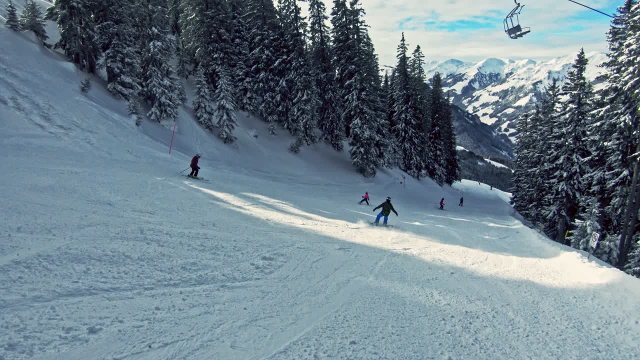Snowboarding down the slope surrounded by snowy nature