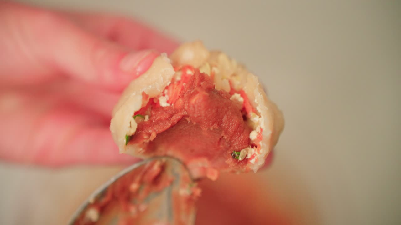 Eating a fresh steamed dumpling with peanut sauce