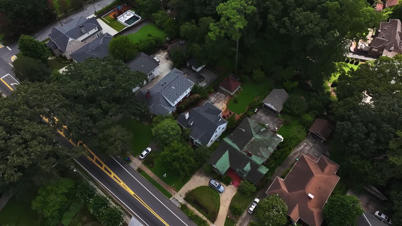Suburb neighborhood with luxury mansions in Atlanta, Georgia. Green garden and colored facade. Aerial top down flyover