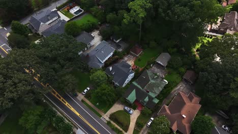 suburb neighborhood with luxury mansions in atlanta, georgia. green garden and colored facade. aerial top down flyover