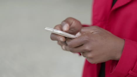 Close-up-shot-of-Afro-american-female-hands-texting-on-phone