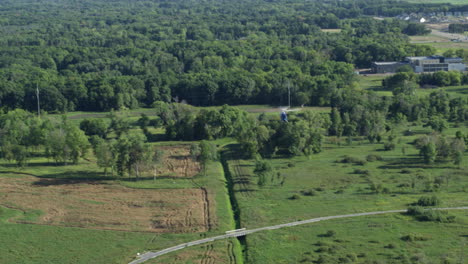 Aerial-of-Life-Link-rescue-helicopter-flying-over-rural-countryside-green-fields