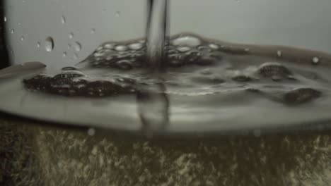 white wine pouring into a glass macro shot