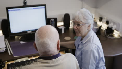 nurse assisting elderly patient with computer