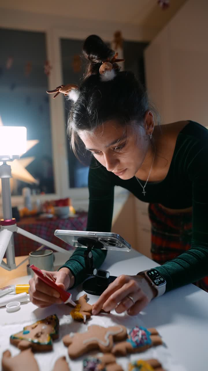 Woman decorating Christmas cookies