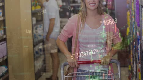 animation of financial data processing over caucasian woman with shopping trolley