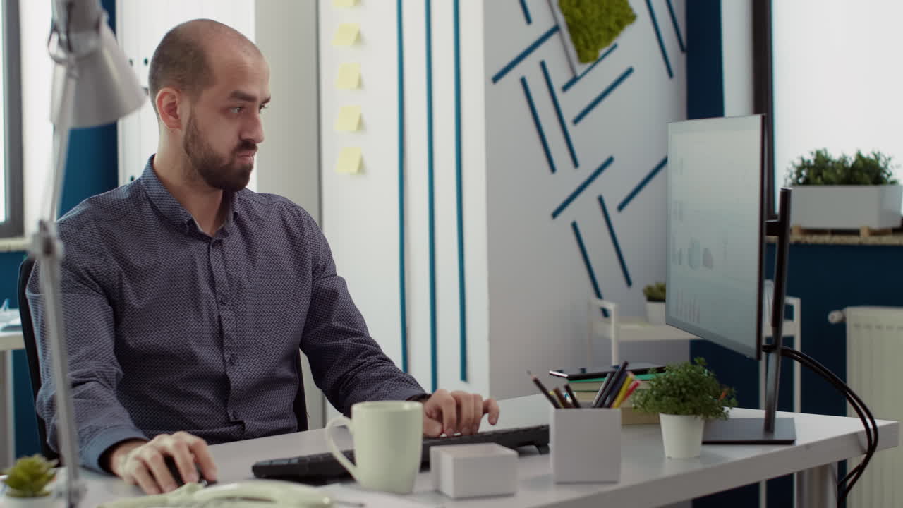 Business man looking at financial statistics on computer