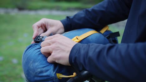 A-man-is-attaching-his-tent-to-his-bicycle-handlebars