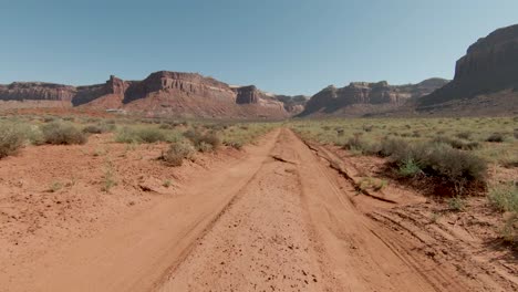 aerial-FPV-motion-following-the-path-in-order-to-the-huge-cliffs-in-amazing-Indian-Creek-with-sunny-day