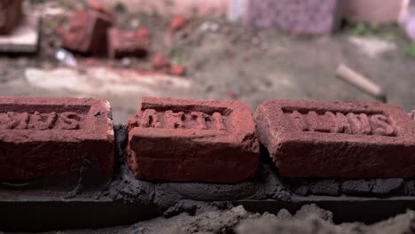 black labor working on construction site contractor building wall with brick and concrete