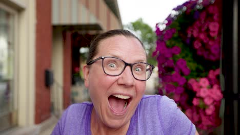 girl smiles big with an astonishing expression while looking at the camera