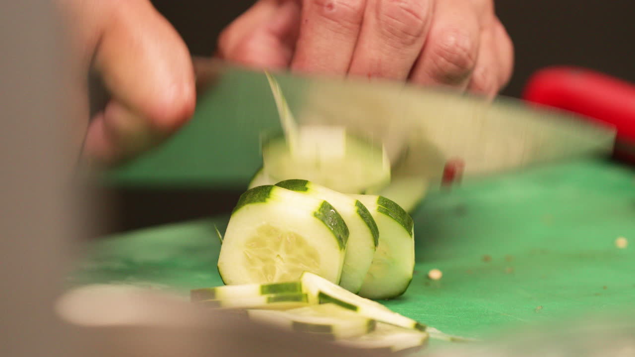 Skilled Chef Chopping Cucumber In The Kitchen Of A Restaurant. - close up shot