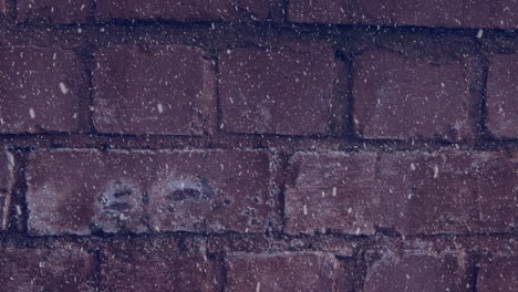 animation of winter scenery snow falling against brick wall