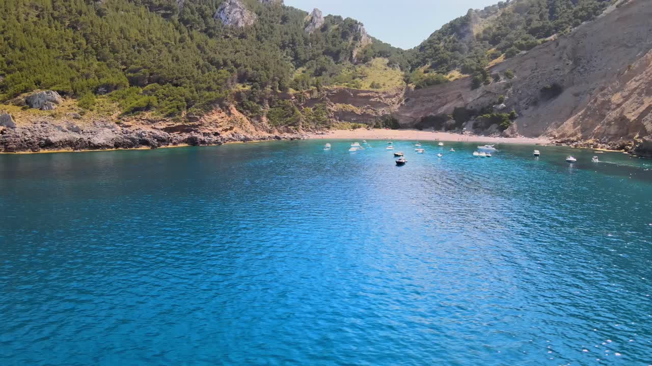 Coll Baix in Puerto de Alcudia offers stunning views of crystal-clear waters and beautiful surrounding hills. Enjoy a peaceful day on the beach, perfect for relaxation and water activities.