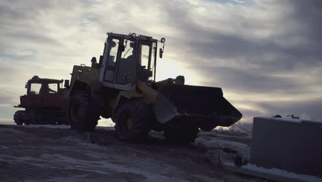 heavy machinery operation in winter construction site