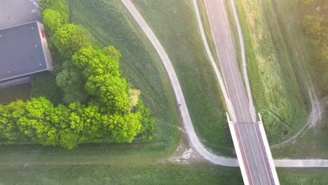 aerial view of urban park and road network with bridge and buildings