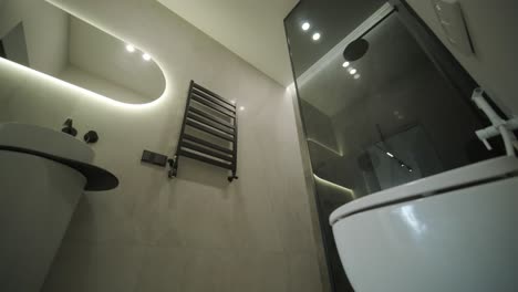 modern bathroom with wall-mounted toilet and gray tile design