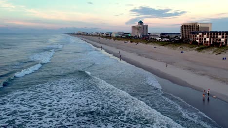 Aerial-of-surf-rollling-into-carolina-beach-nc,-north-carolina-at-sunrise