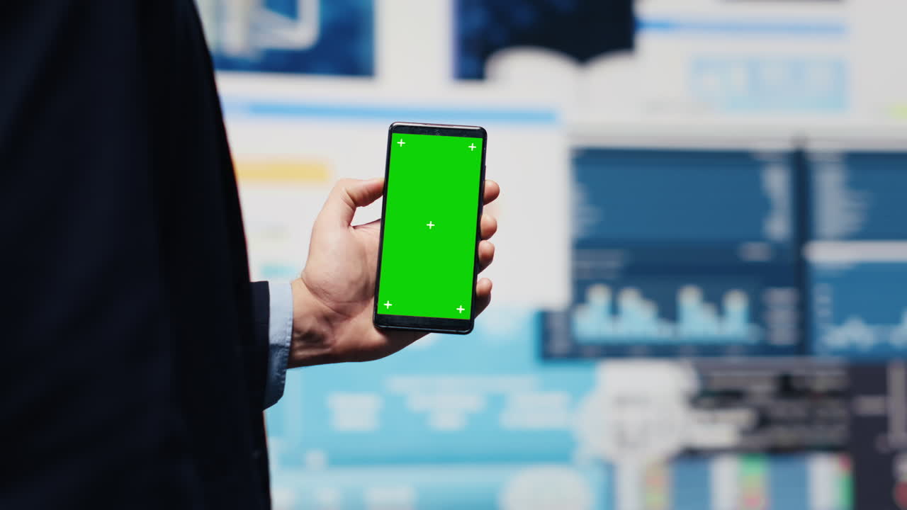 Male administrator uses green screen phone to explore new growth strategy