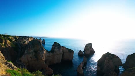 drone fly over sea pillars of ponta da piedade in lagos, portugal. fpv shot