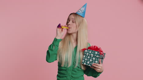 happy excited lucky woman wearing birthday hat cone blow pipe celebrating party success win victory