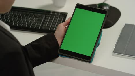 cu mujer en el escritorio tiene tableta con pantalla verde