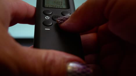 close up of hands pressing buttons on a light meter, on off button turns lights off and on