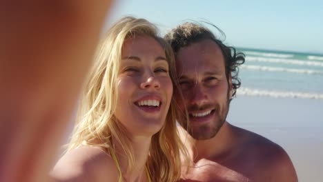 Couple-standing-together-at-beach