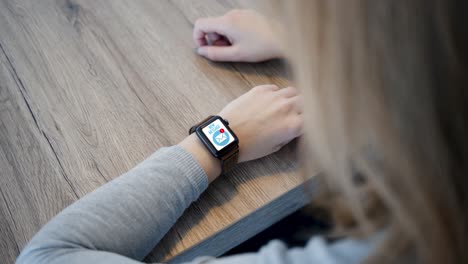 smart watch - incoming message on screen - over shoulder - slow motion