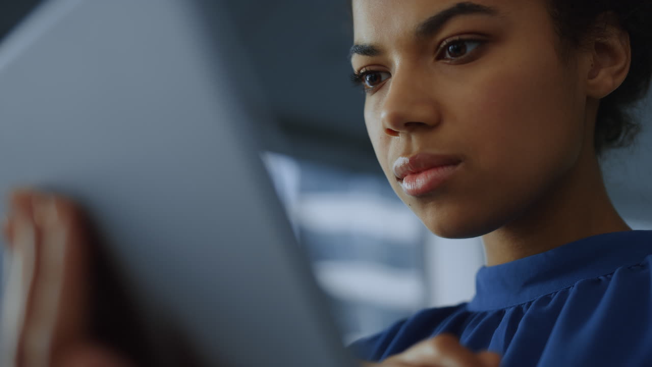 Business woman reading financial report on tablet computer