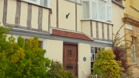 exterior view of a traditional house with bay windows and timber beams