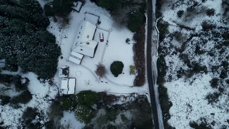 bird eye view of a mountain road next to a mountain house in a snow day - dublin mountains - ireland