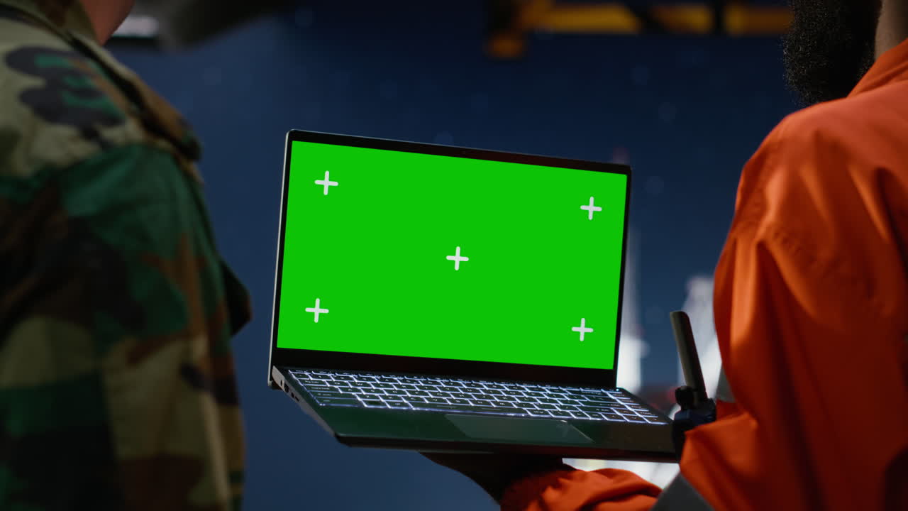 Chroma key laptop next to military soldier handling a maritime patrol