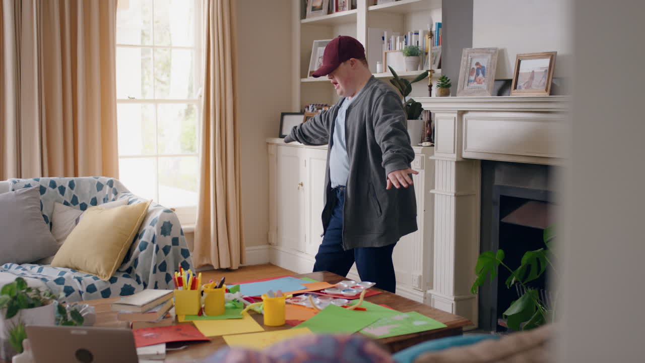 funny teenage boy with down syndrome dancing in living room having fun celebrating with silly dance moves happy kid enjoying weekend at home 4k