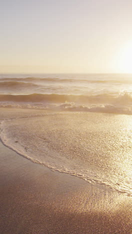 sunset and sea with waves and blue sky on empty sunny beach